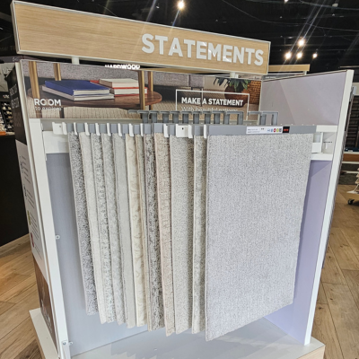 Statements flooring display showcasing neutral-toned carpet samples with a 